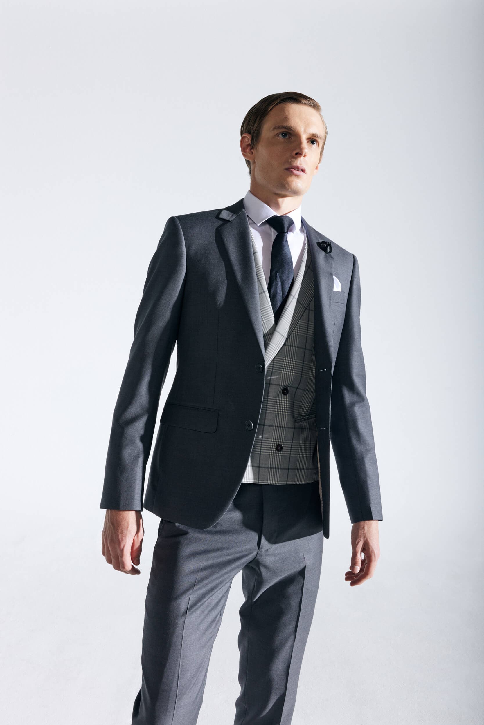 Groom in tailored Knightsman tuxedo next to bridal elegance